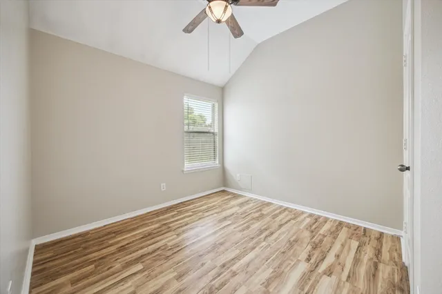 a view of room with window and ceiling fan