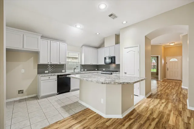 a kitchen with stainless steel appliances granite countertop a stove and a sink