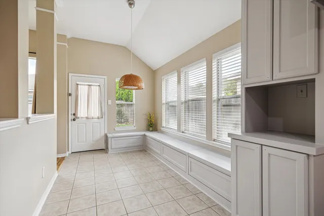 a view of room with flat screen tv and windows