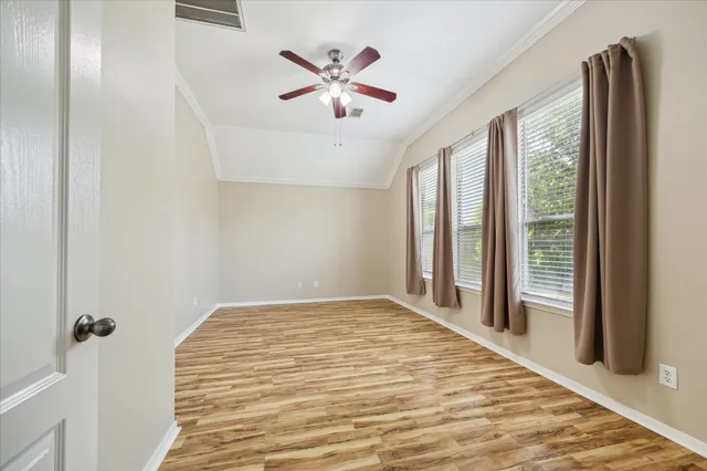a view of a livingroom with a ceiling fan and window