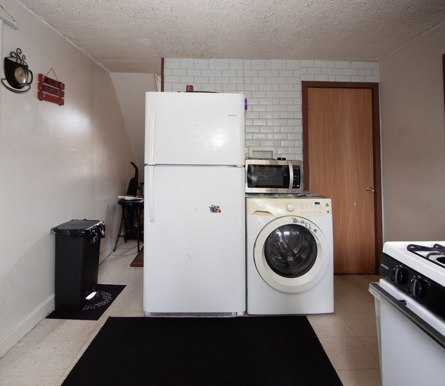 66 Cutler Street Worcester, MA 01604 - Photo 23 of 27 a view of a kitchen with washer and dryer
