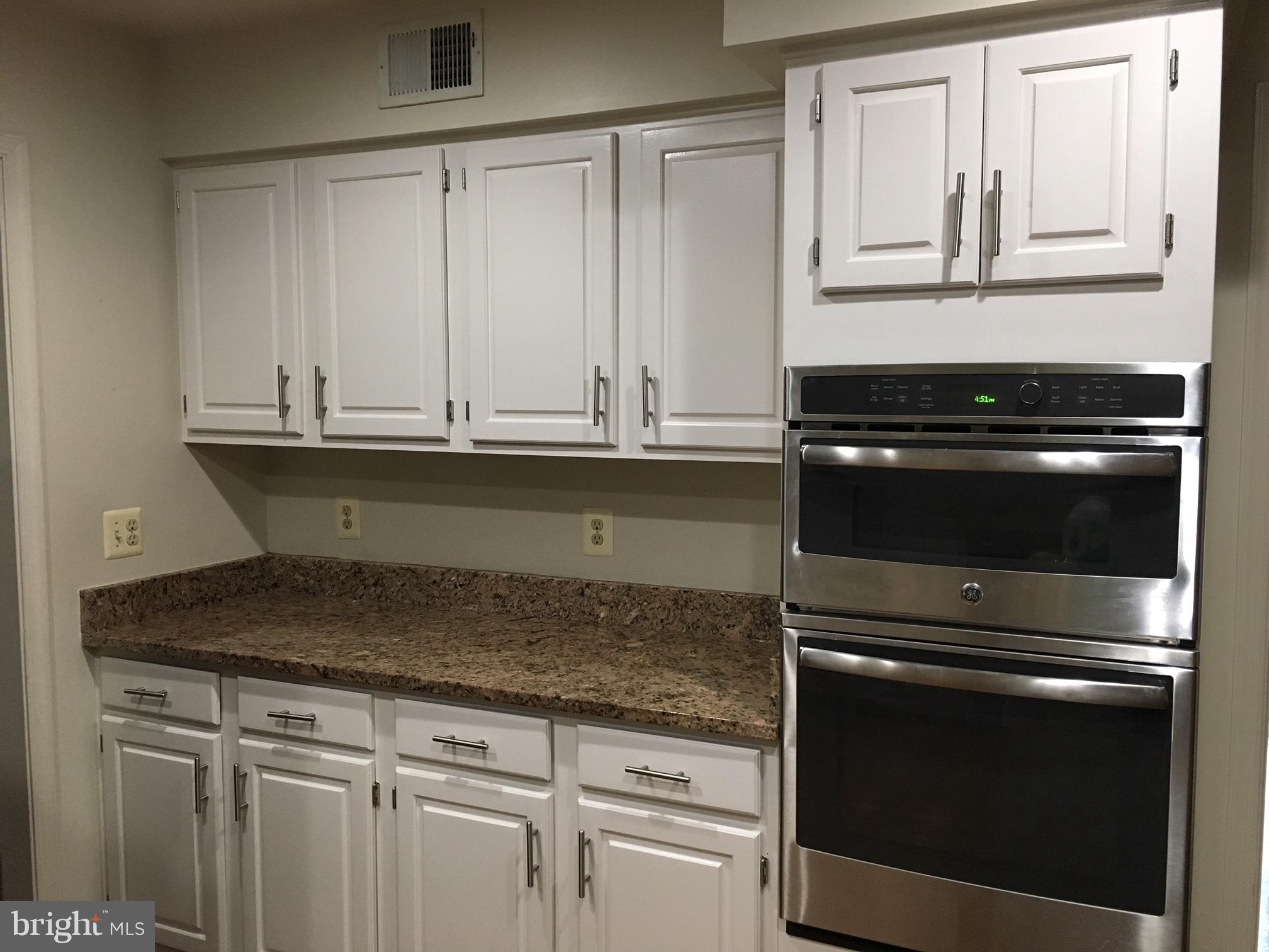 4269 Exeter Drive Dumfries, VA 22025 - Photo 10 of 32 a kitchen with granite countertop white cabinets and a stove