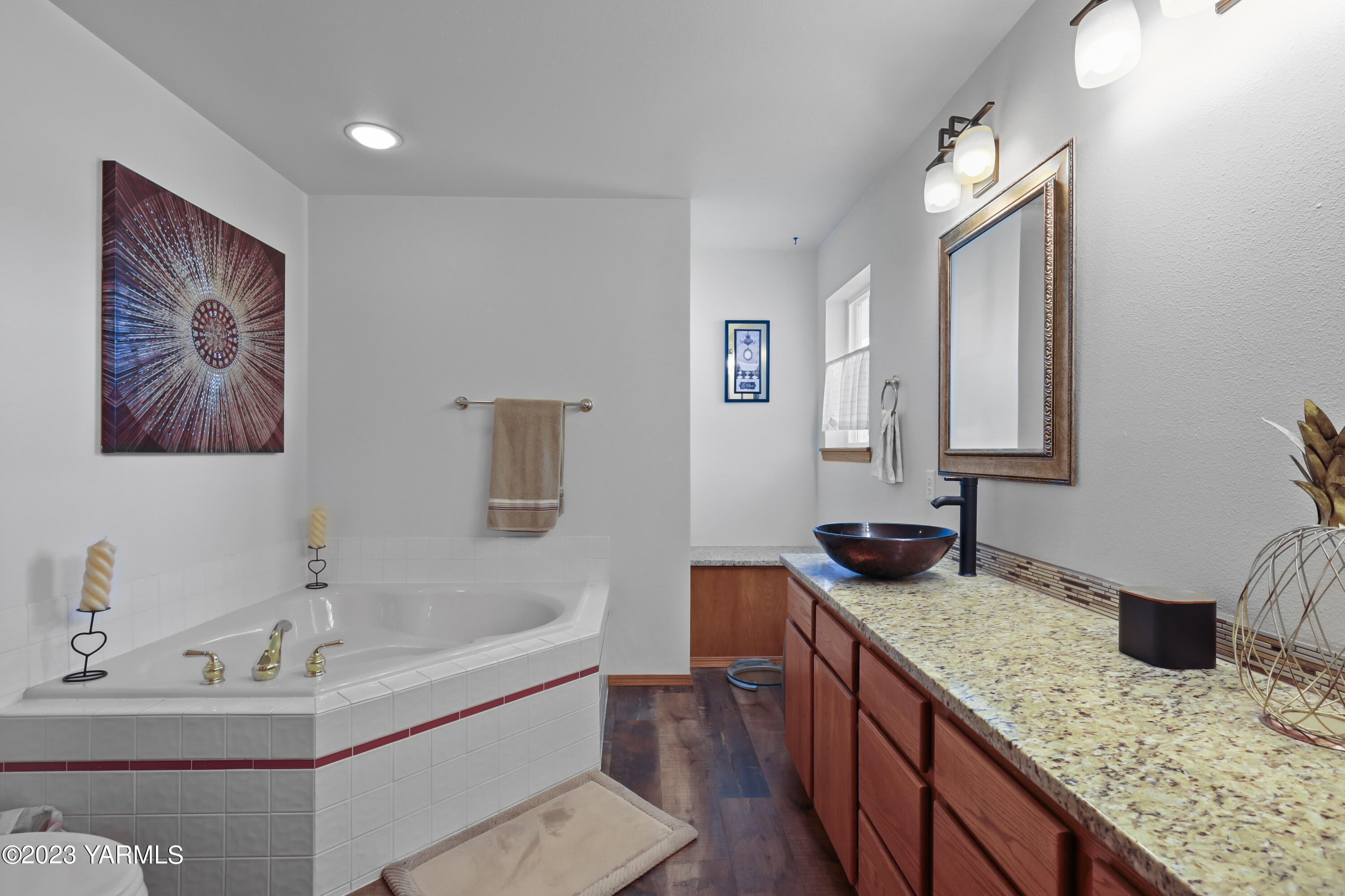 380 Wilson Road Yakima, WA 98901 - Photo 14 of 28 a bathroom with a granite countertop sink and a mirror