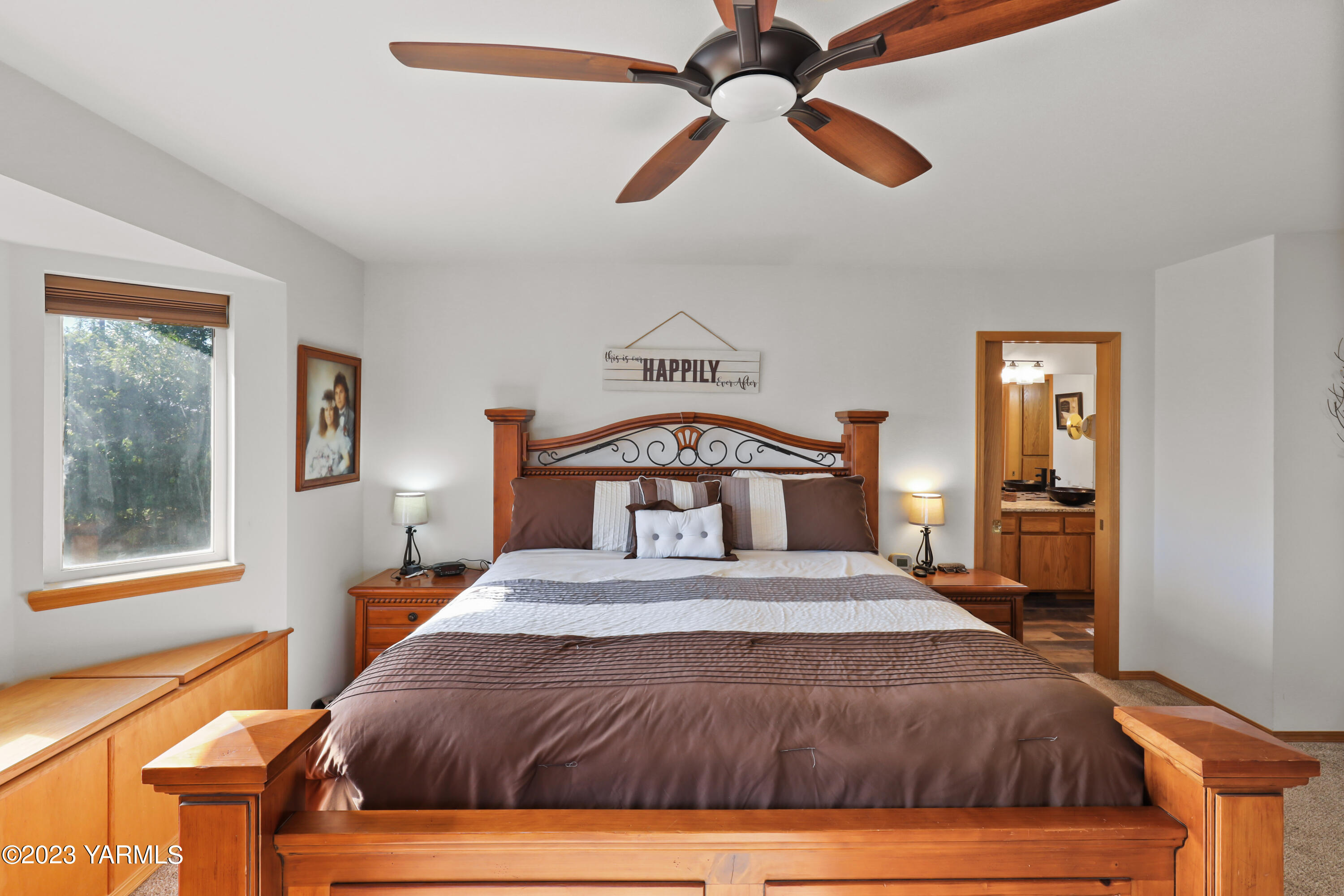 380 Wilson Road Yakima, WA 98901 - Photo 17 of 28 a bedroom with a large bed and a chandelier