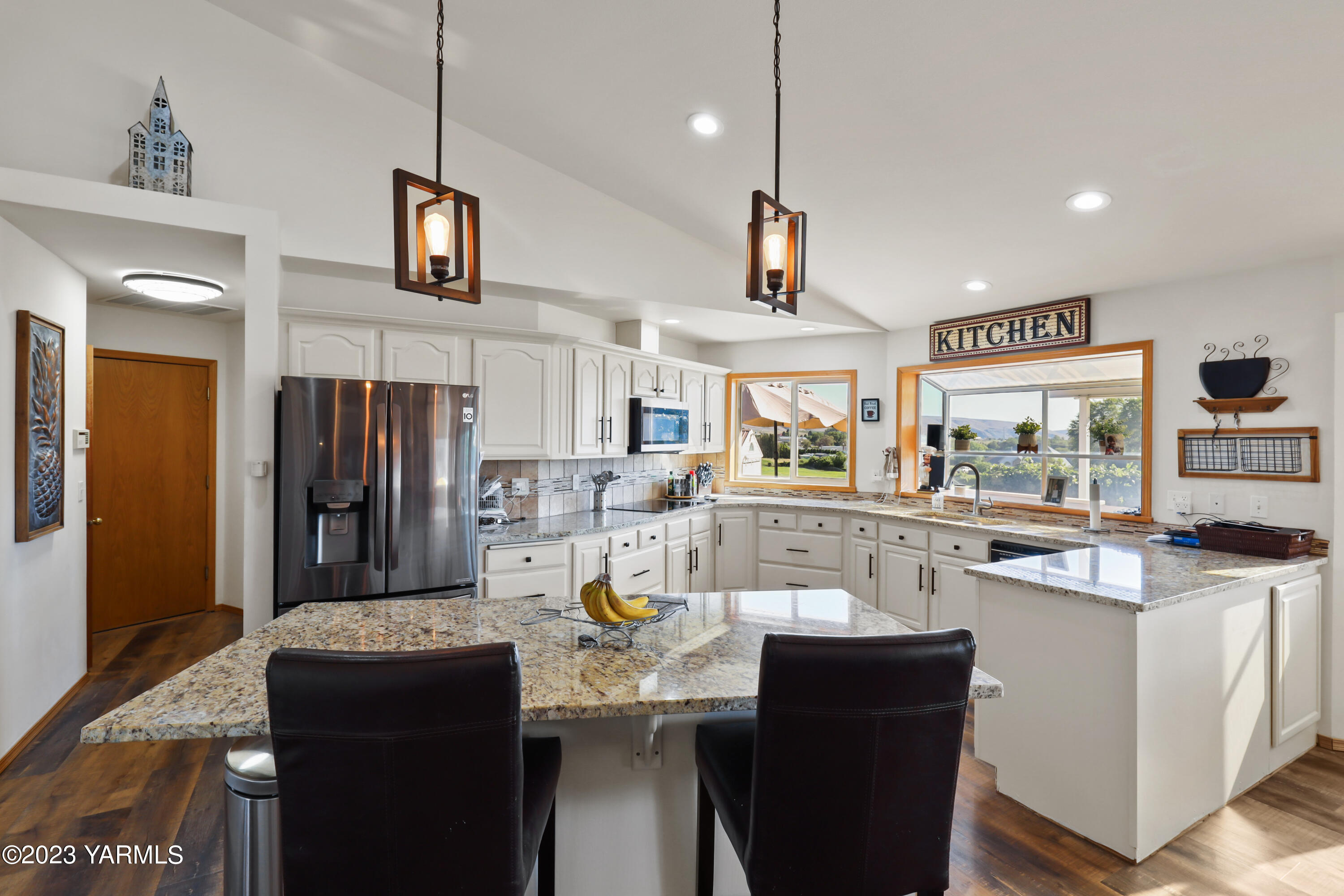380 Wilson Road Yakima, WA 98901 - Photo 6 of 28 a kitchen with stainless steel appliances kitchen island granite countertop a sink a stove and a refrigerator