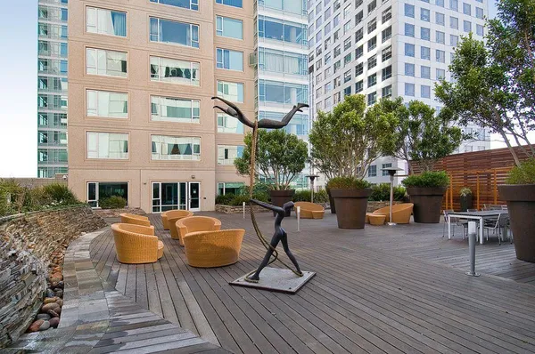 a view of a building with sitting area and furniture