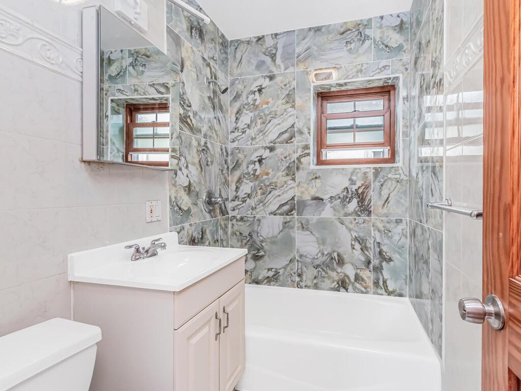 57-07 146th Street Queens, NY 11355 - Photo 11 of 19 a bathroom with a sink and a bathtub
