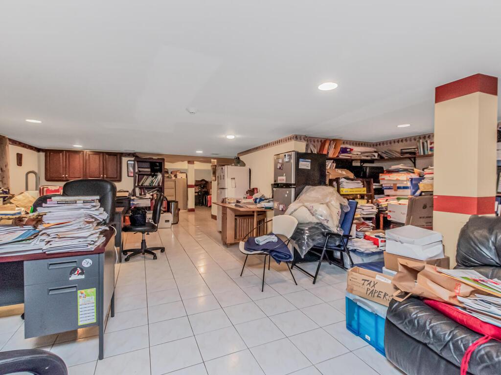 57-07 146th Street Queens, NY 11355 - Photo 15 of 19 a living room with lots of furniture and clutter