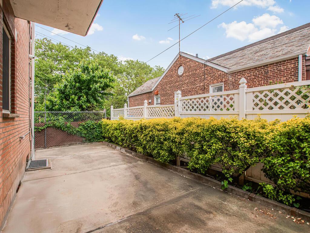 57-07 146th Street Queens, NY 11355 - Photo 17 of 19 a view of a house with a small yard