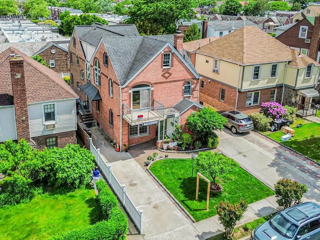 an aerial view of a house with a yard