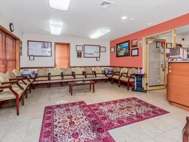 a living room with furniture a rug and wooden floor