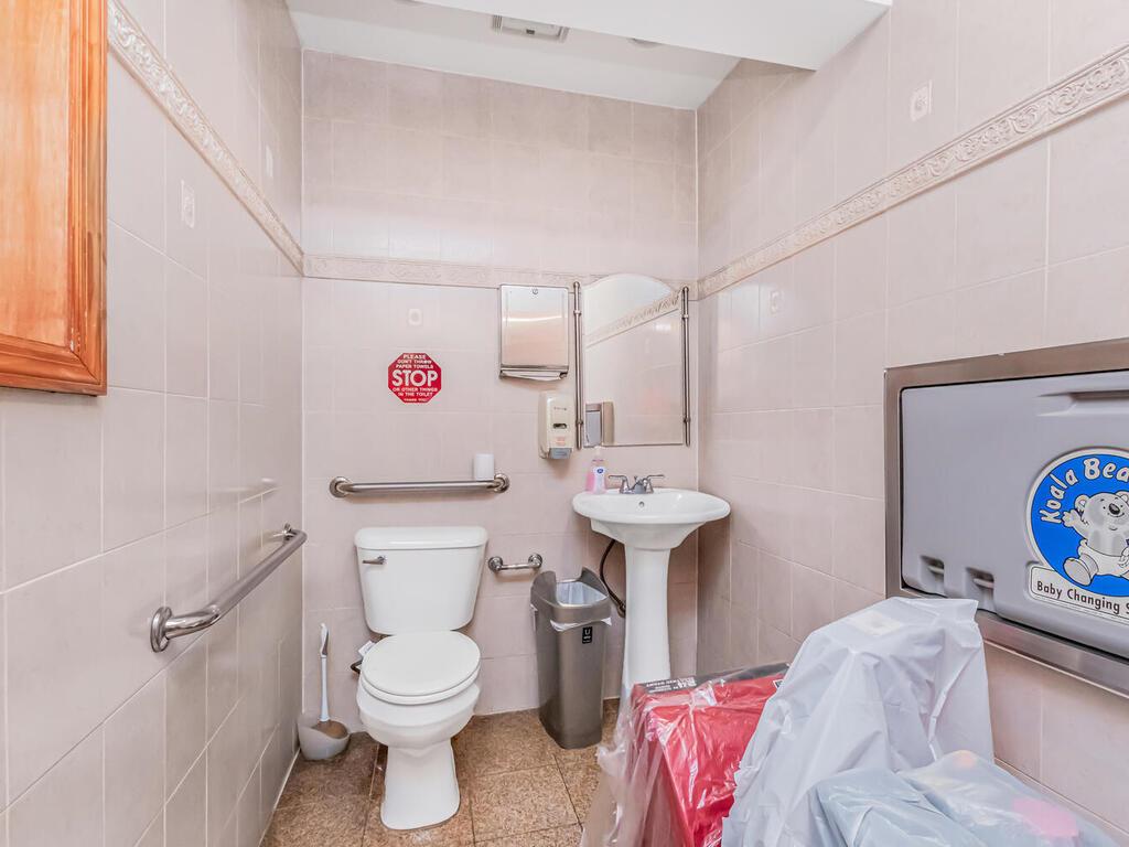 57-07 146th Street Queens, NY 11355 - Photo 5 of 19 a bathroom with a sink toilet and a mirror