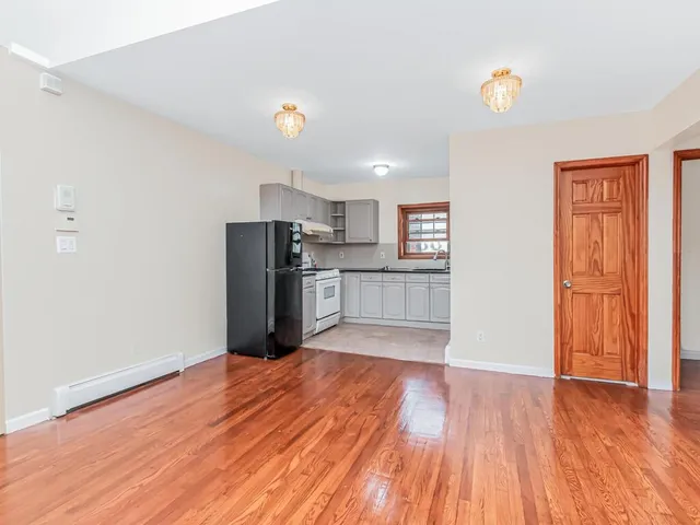 a view of kitchen with wooden floor and electronic appliances