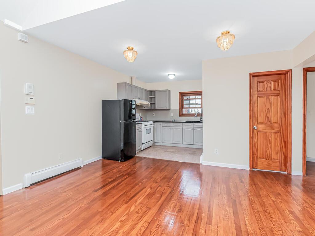 57-07 146th Street Queens, NY 11355 - Photo 8 of 19 a view of kitchen with wooden floor and electronic appliances