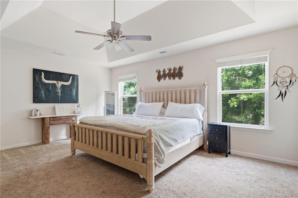 123 Renford Road Ball Ground, GA 30107 - Photo 14 of 27 a bedroom with a bed lamp and window