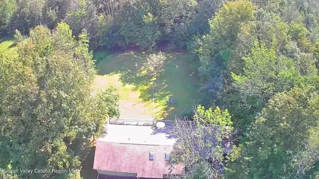 a view of a mountain range with lush green forest