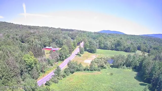 a view of a town with mountains in the background