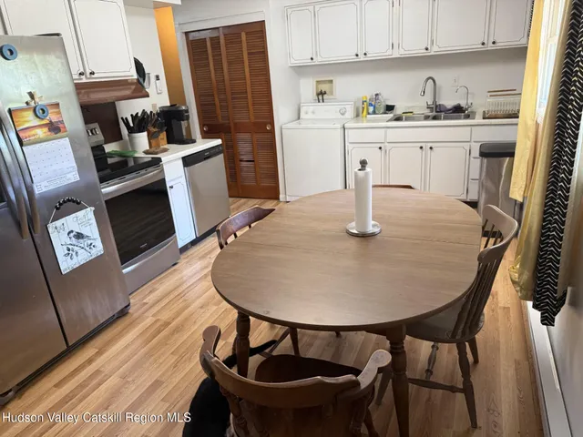 a dining room with furniture and wooden floor