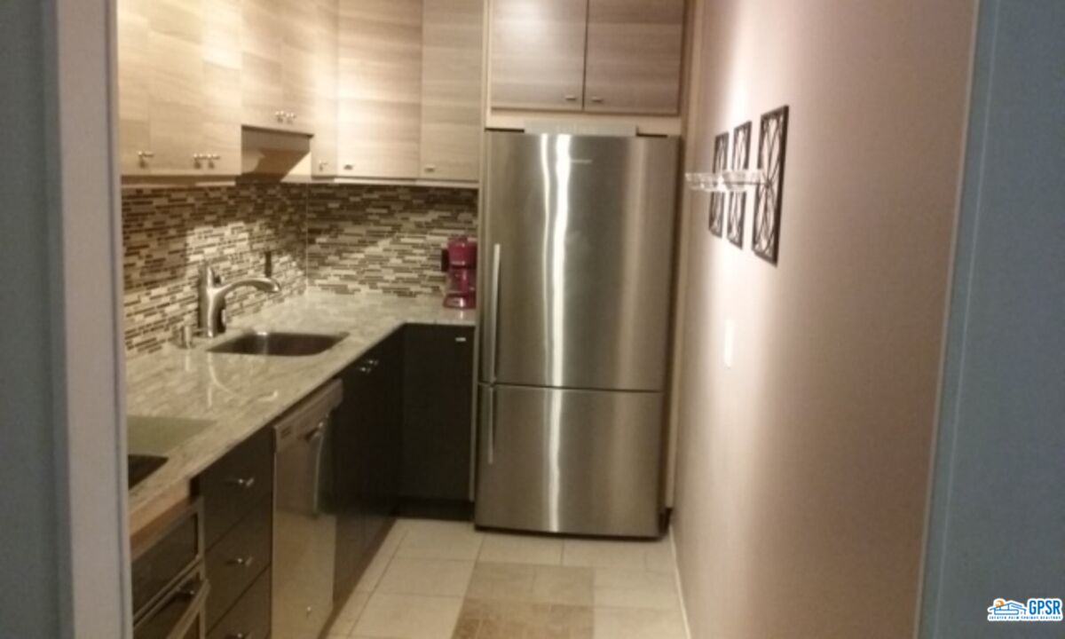 a kitchen with a refrigerator and countertop