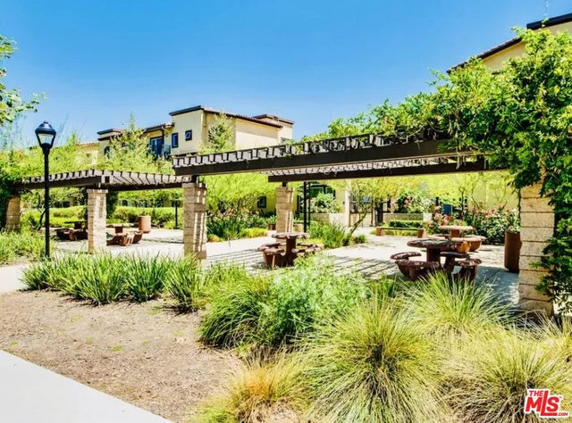 a view of swimming pool with outdoor seating and plants