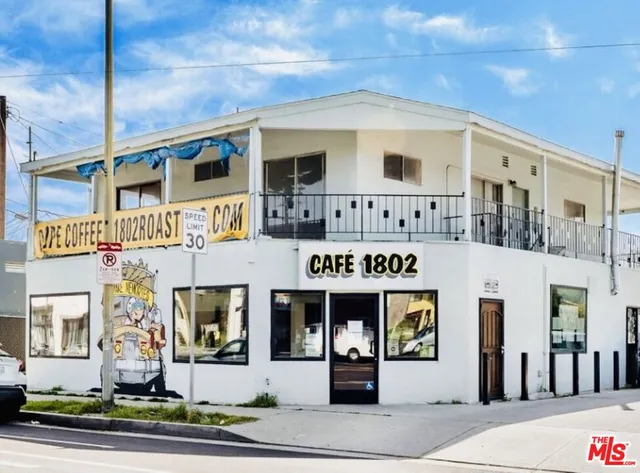a front view of a building with retail shops