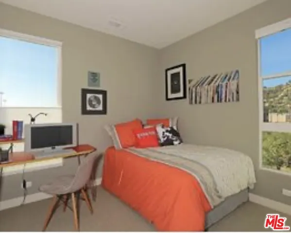 a bedroom with a bed and a table in it