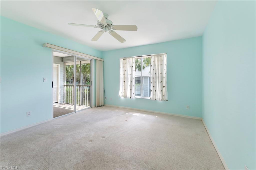 1915 Courtyard Way, Unit G202 Naples, FL 34112 - Photo 11 of 22 Primary bedroom room featuring ceiling fan and carpet