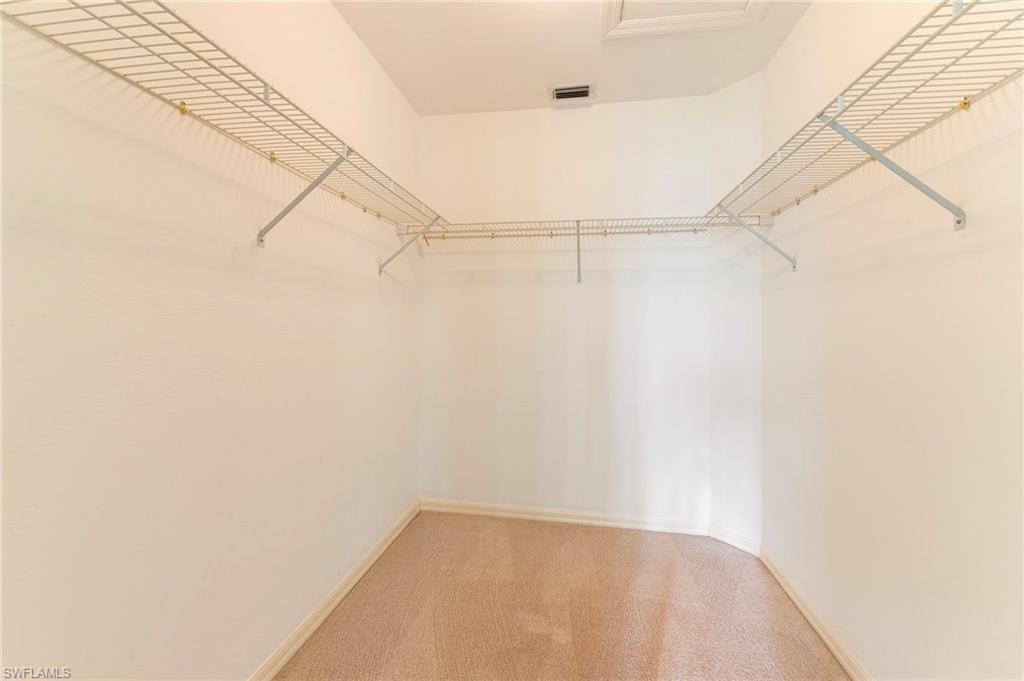 1915 Courtyard Way, Unit G202 Naples, FL 34112 - Photo 12 of 22 Walk in closet featuring carpet floors