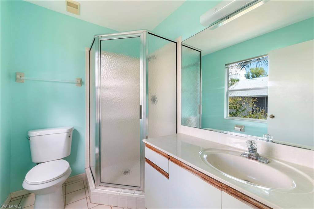 1915 Courtyard Way, Unit G202 Naples, FL 34112 - Photo 13 of 22 Bathroom with vanity, light tile patterned flooring, and a shower stall