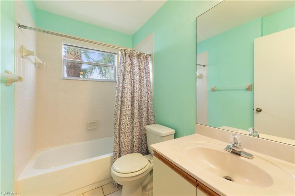 1915 Courtyard Way, Unit G202 Naples, FL 34112 - Photo 15 of 22 Bathroom featuring vanity, shower / bath combo, and tile patterned floors