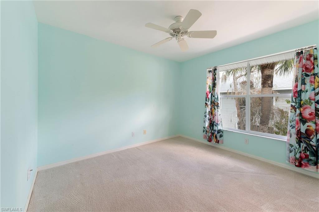 1915 Courtyard Way, Unit G202 Naples, FL 34112 - Photo 16 of 22 Spare room featuring carpet and ceiling fan