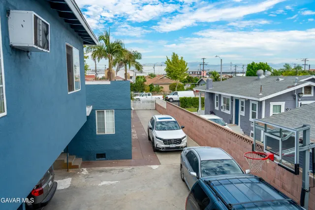 an aerial view of multiple houses with a yard