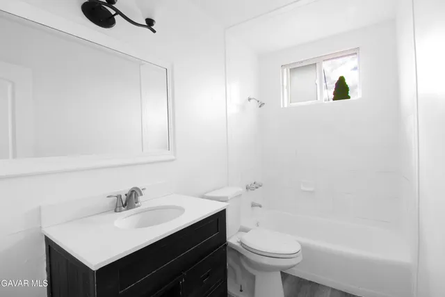 a bathroom with a sink toilet and a mirror