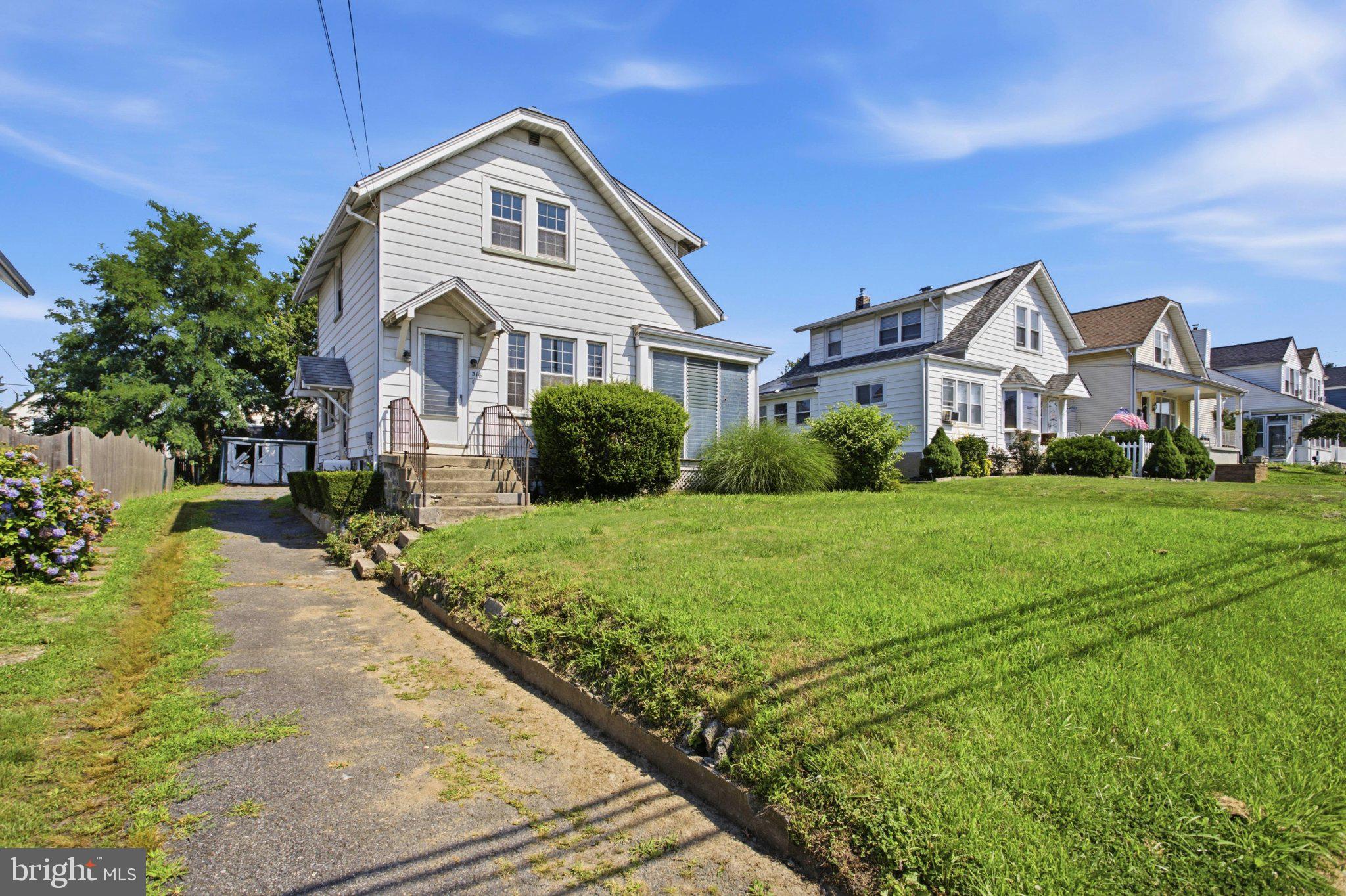 316 Powell Road Springfield, PA 19064 - Photo 2 of 23 Charming home with lush green lawn.