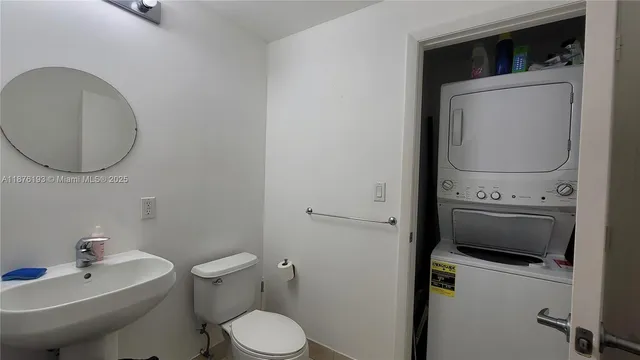 a bathroom with a toilet a sink and a mirror