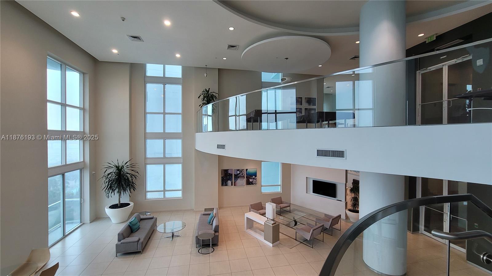 1900 North Bayshore Drive, Unit 2009 Miami, FL 33132 - Photo 20 of 26 a living room with stainless steel appliances furniture a rug and a large window