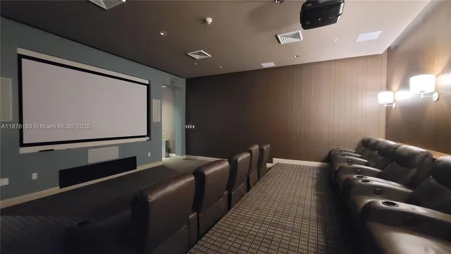 a living room with stainless steel appliances furniture a kitchen view and a large window