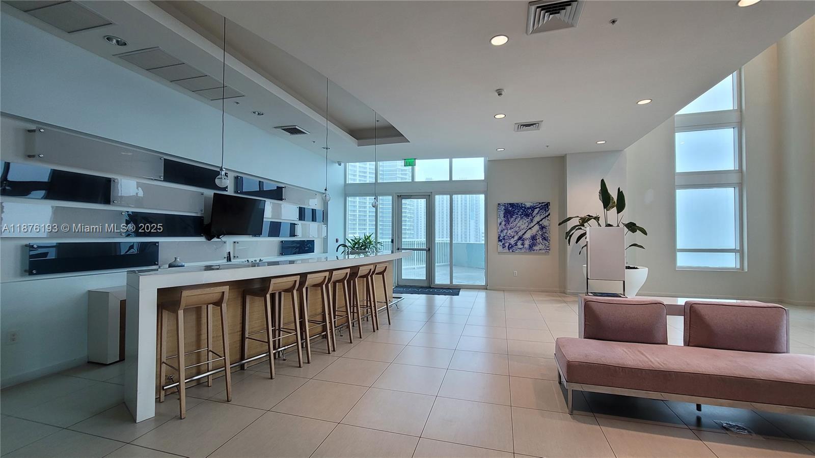 1900 North Bayshore Drive, Unit 2009 Miami, FL 33132 - Photo 24 of 26 a living room with stainless steel appliances furniture a kitchen view and a large window
