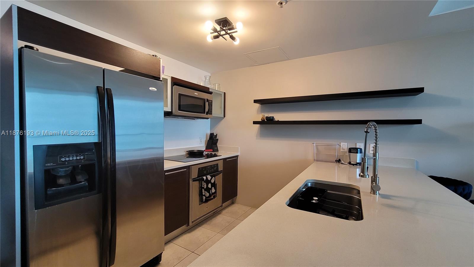 1900 North Bayshore Drive, Unit 2009 Miami, FL 33132 - Photo 3 of 26 a kitchen with stainless steel appliances a refrigerator a stove and a sink