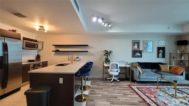 a living room with furniture a rug and a flat screen tv