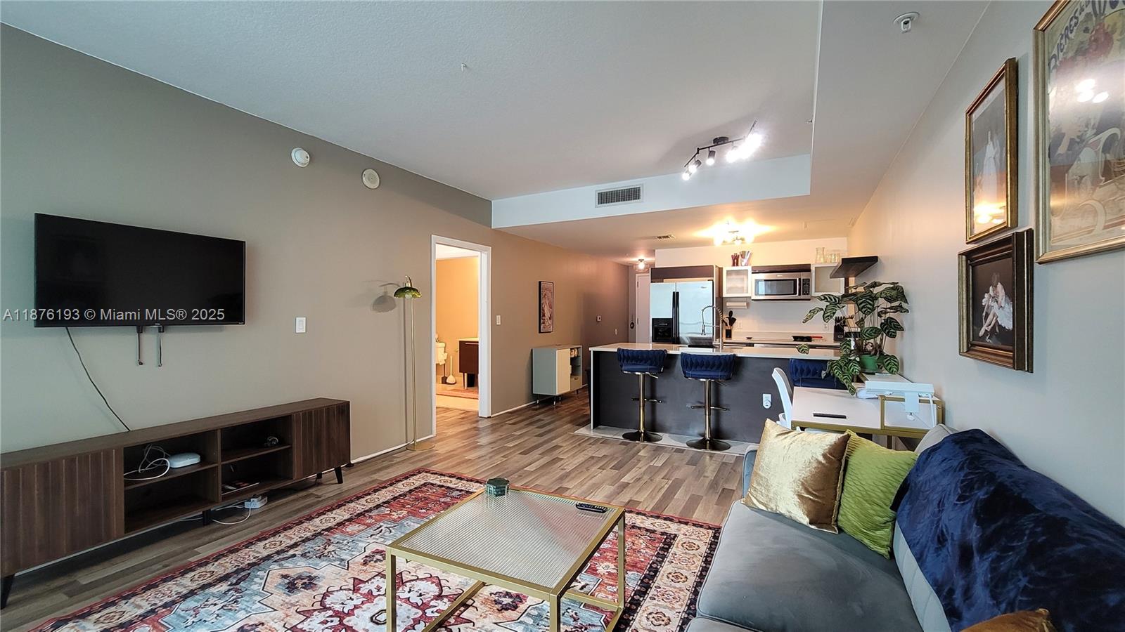 1900 North Bayshore Drive, Unit 2009 Miami, FL 33132 - Photo 7 of 26 a living room with furniture and a flat screen tv