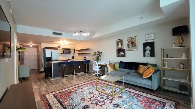 a living room with furniture and a rug