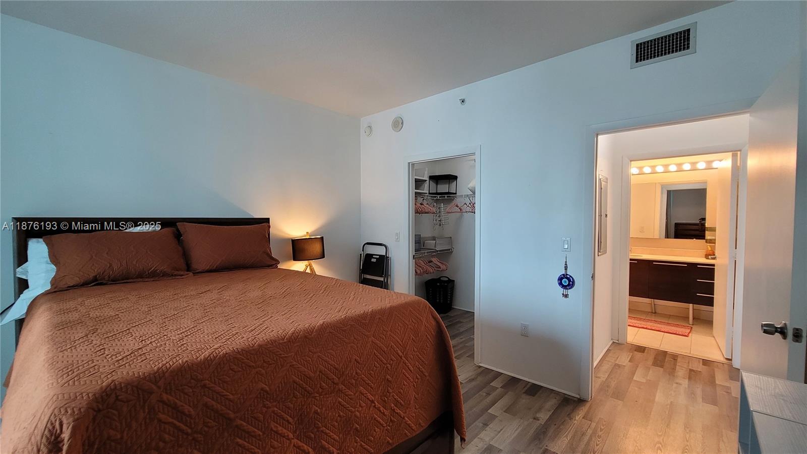 1900 North Bayshore Drive, Unit 2009 Miami, FL 33132 - Photo 9 of 26 a bedroom with a bed and wooden floor