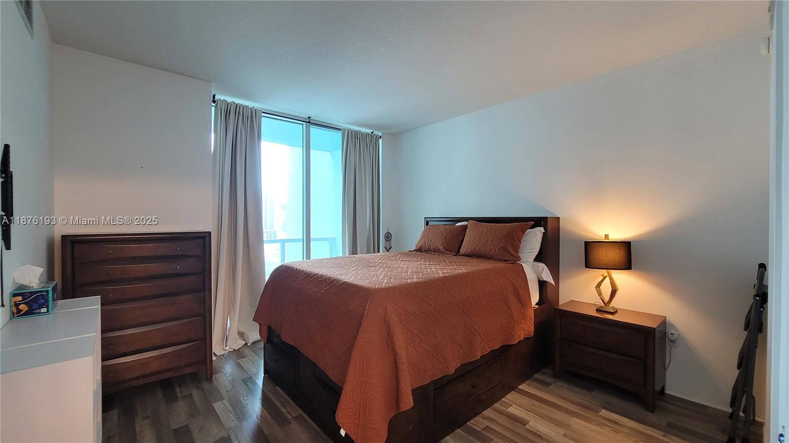 1900 North Bayshore Drive, Unit 2009 Miami, FL 33132 - Photo 10 of 26 a bedroom with a bed and wooden floor