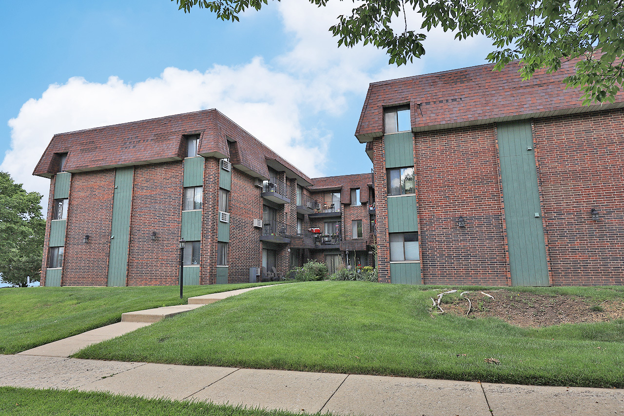 4946 Douglas Road, Unit 202 Downers Grove, IL 60515 - Photo 1 of 19 a brick building with a yard