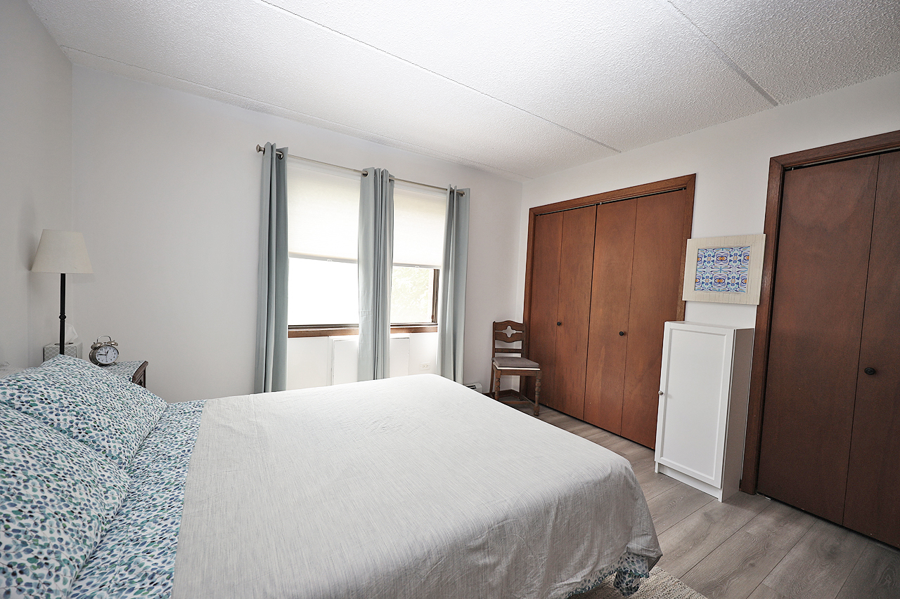 4946 Douglas Road, Unit 202 Downers Grove, IL 60515 - Photo 12 of 19 a bedroom with a bed and a window