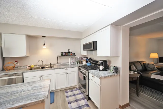 a kitchen with a sink stove and cabinets