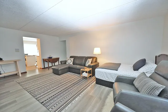 a living room with furniture and wooden floor