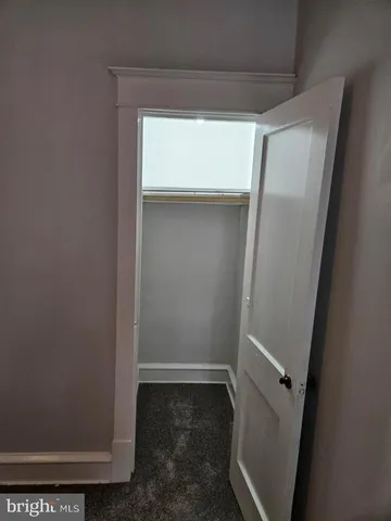 a view of storage and utility room with wooden floor