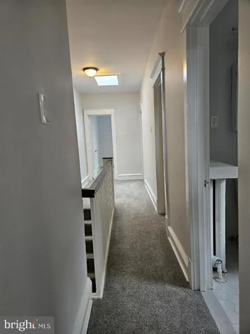 a view of a hallway with paintings on the wall